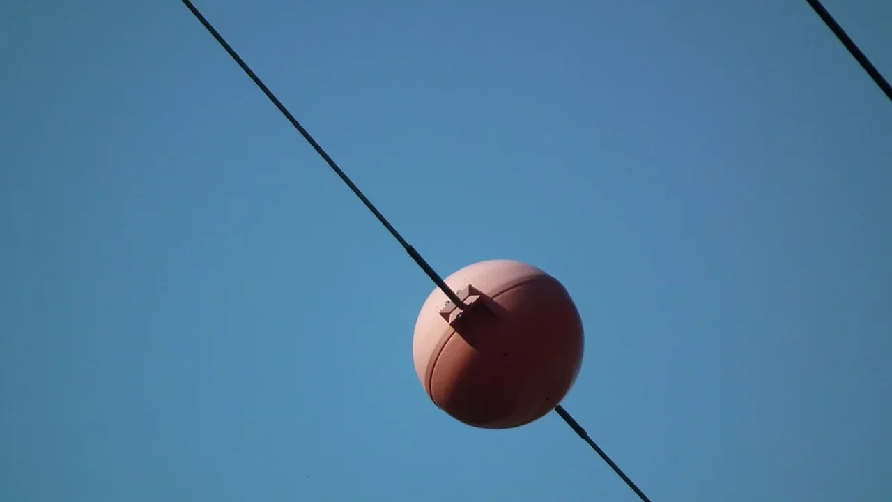Power Lines' Orange Spheres: A Simple Safety Signal in the Sky